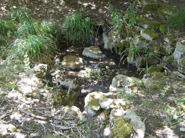 A pool surrounded by pieces of yellow stone